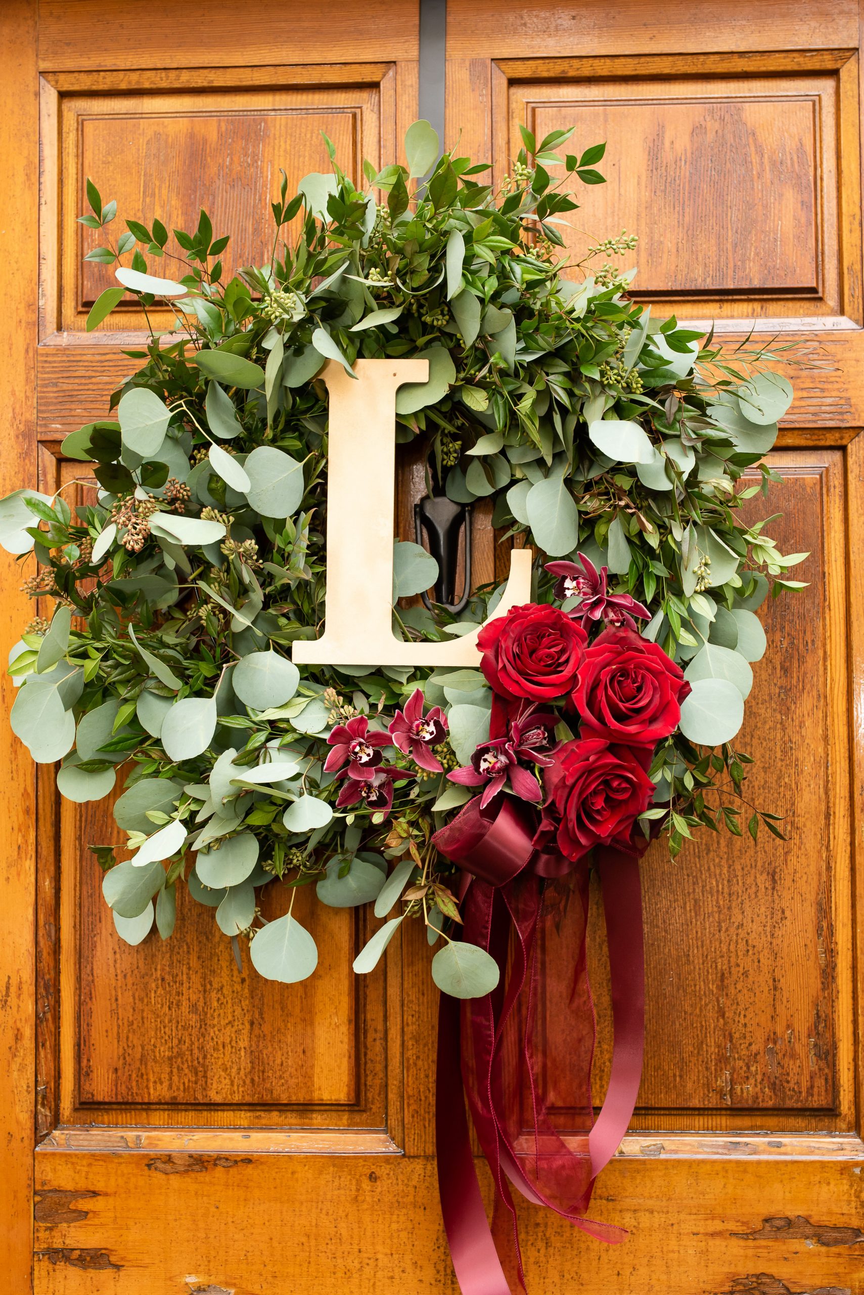Stems Atlanta Wedding Florist, Atlanta Wedding Planner, www.stemsatlanta.com, Beautiful Surprise Winter Wedding at a residence featuring a flowing wreath with whimsical Eucalyptus and accents of Red Roses.